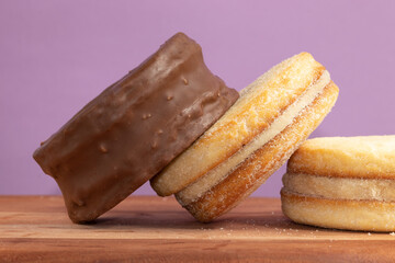 Close up of alfajores stuffed  with dulce de leche covered with chocolate.