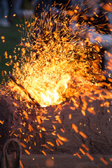 Forging outdoors and sparkles around macro 