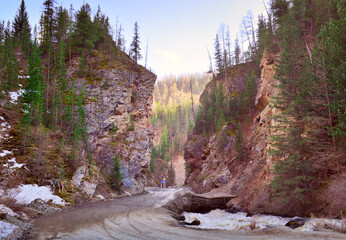 Red Gate Gorge in the Altai Mountains. The road between the high rocks along the mountain river Chibitka in the spring. Nature of Siberia, Russia