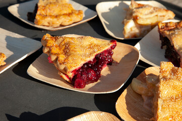 Slices of fruit pie on separate plates ready to serve to guests