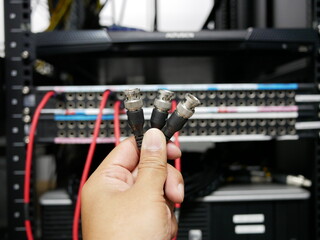 hand holding BNC cable connector in the TV station.
