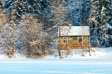 old house in the winter forest