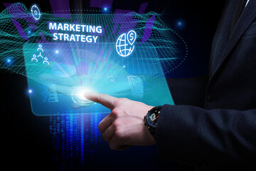 Business, Technology, Internet and network concept. Young businessman working on a virtual screen of the future and sees the inscription: Marketing strategy
