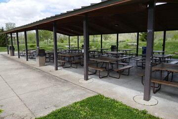 Fototapeta na wymiar Modern public park shelter house with several picnic tables