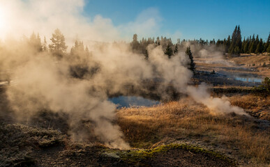 dramatic frosty and foggy autumn morning covering the yellowstone lake , hot sprinngs and cones in the West Thumb Geyser basin in Yellowstone national park in Wyoming.