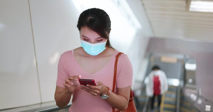 woman use phone with mask