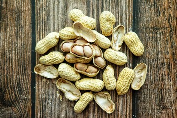 Peanuts on wooden background.