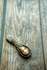 Peanuts on wooden spoon.