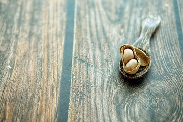 Peanuts on wooden spoon.