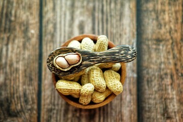 Peanuts on wooden spoon.
