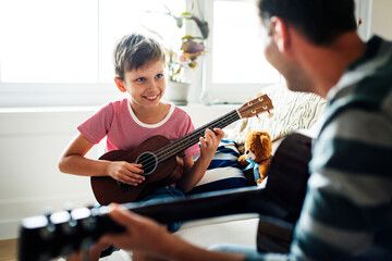 Fototapeta na wymiar Young boy playing guitar