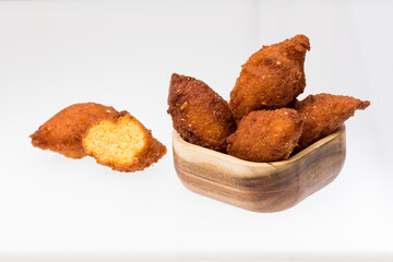 Tasty fried sweet corn croquettes; photo on white background.