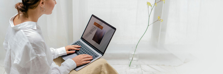 Woman using a laptop on a bean bag