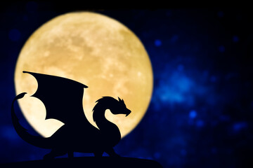 Obraz na płótnie Canvas Dragon silhouette over a full moon