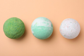 Colorful bath bombs on beige background, flat lay