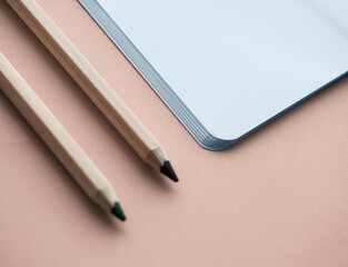 Blank notebook and pencil isolated on background