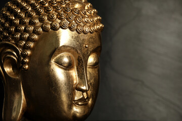 Buddha statue on dark background, closeup. Space for text