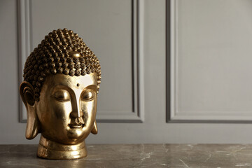 Buddha statue on grey table. Space for text