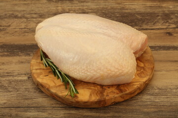 Raw whole chicken breast with skin