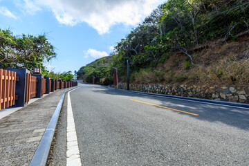Mountain road landscape under blue sky.