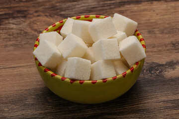 Refined white sugar cubs in the bowl