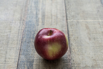 One fresh red apple on a wooden tabletop fruit diet