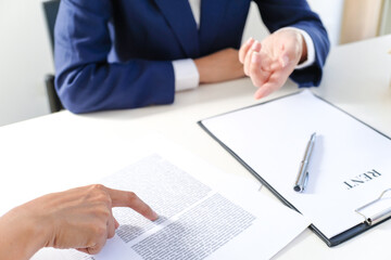 Sales manager giving advice application form document, considering mortgage loan offer for car and house insurance.