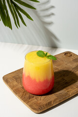 Layered mango and strawberry smoothie