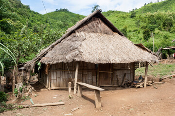 Fototapeta na wymiar Laos - Traditional Hmong huts with thatched roof, hill tribe village, Luang Prabang province in northern Laos 