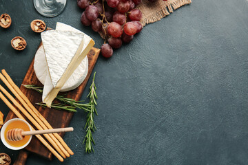 Composition with tasty cheese on dark background