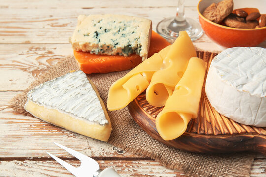 Different types of cheese on light background, closeup
