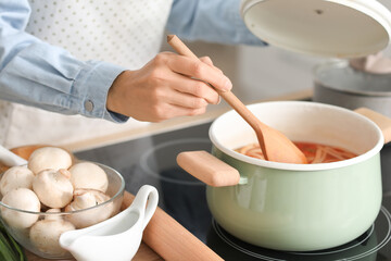 Young woman cooking in kitchen