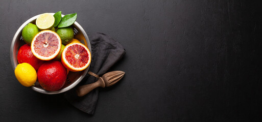 Various fresh citrus fruits in colander. Bood orange, lime, lemon
