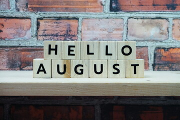 Hello August alphabet letter on shelves wooden background