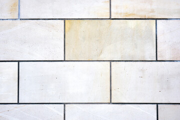 Background from a wall with rectangular white stone slabs