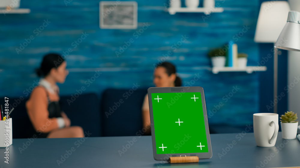 Aufkleber isolated tablet computer with mock up green screen chroma key standing on desk table in living room.