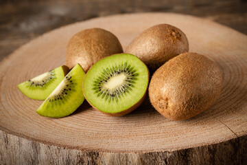 Fresh kiwi fruits on wood, close-up - 434482864