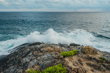 Ocean waves hits rocky shore. Nature background