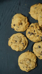 Selective focus of some homemade choco chips cookies with black background