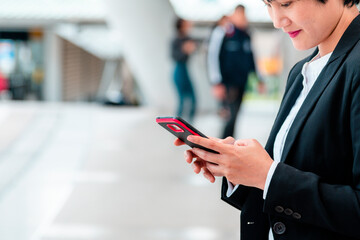 Business woman using smartphone shopping online, call, texting message internet technology lifestyle. Asian woman using cellphone walking on city street. Smart phone smart confident woman modern city