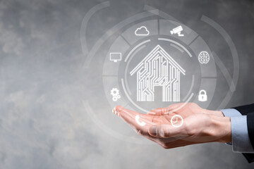 Businessman hold house icon.Smart home controlled, intelligent house, and home automation app concept.Pcb design and person with smart phone. Innovation technology internet Network Concept.
