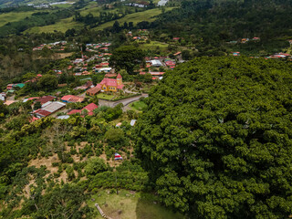 Beautiful aerial view of the Aquiares town and its iconic yellow church in Cartago Costa Rica