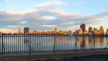 Jacqueline Kennedy Onassis Reservoir behind fenced running track, Manhattan, New York.
