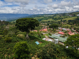 Fototapeta na wymiar Beautiful aerial view of the Aquiares town and its iconic yellow church in Cartago Costa Rica