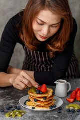 Housewife preparing pancakes