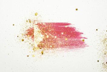 Golden glitter and glittering stars on abstract pink and gold watercolor splash in vintage nostalgic colors