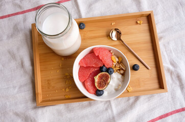 Light and delicious healthy meal / Grapefruit Muesli Bowl and Milk / Pampered yourself having breakfast in bed