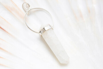 Metal frame mineral stone pendant on white shell background