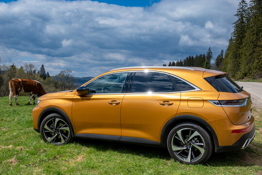 DS 7 Crossback E-Tense 4x4 hybrid on the background of rural landscape