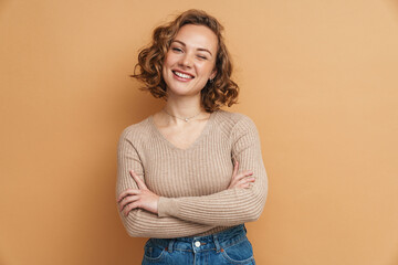 Young ginger woman smiling while posing with arms crossed